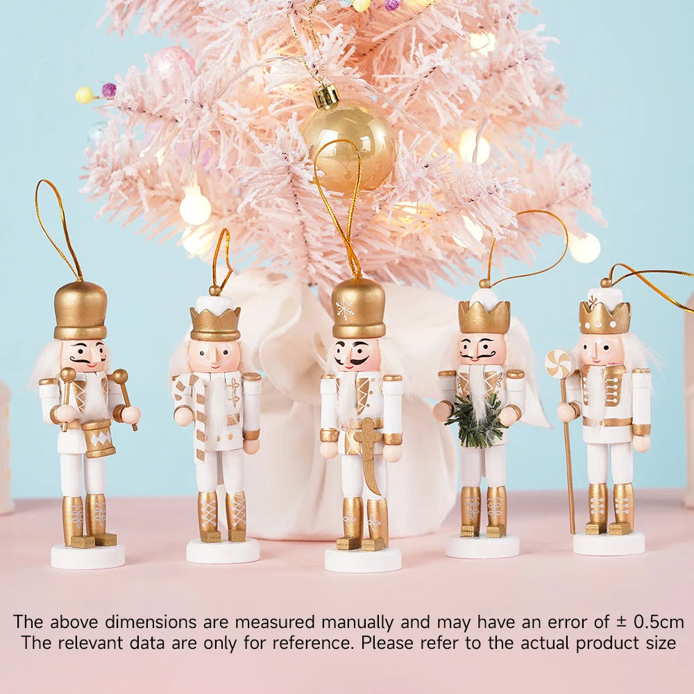 Set of decorative nutcrackers with gold accents in front of a pink Christmas tree.
