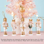Set of decorative nutcrackers with gold accents in front of a pink Christmas tree.
