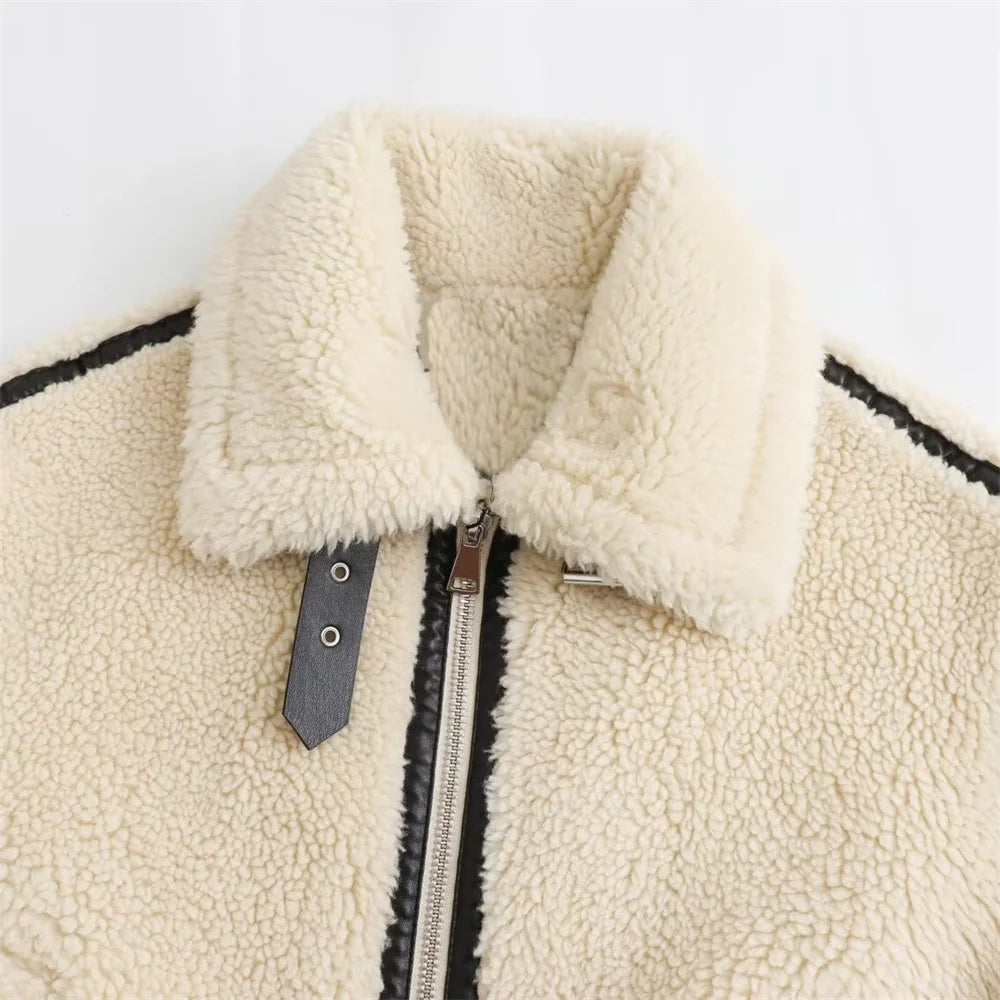 Close-up of a cream-colored fleece jacket with a zipper on a white background