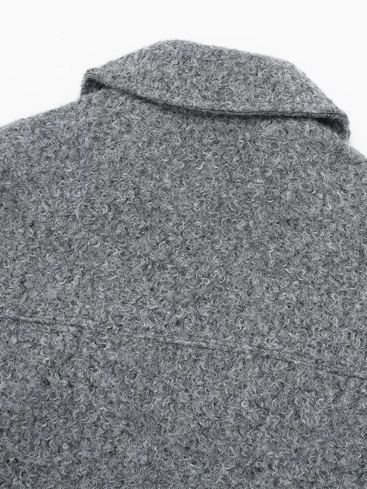 Close-up of a textured gray coat with a collar on a white background