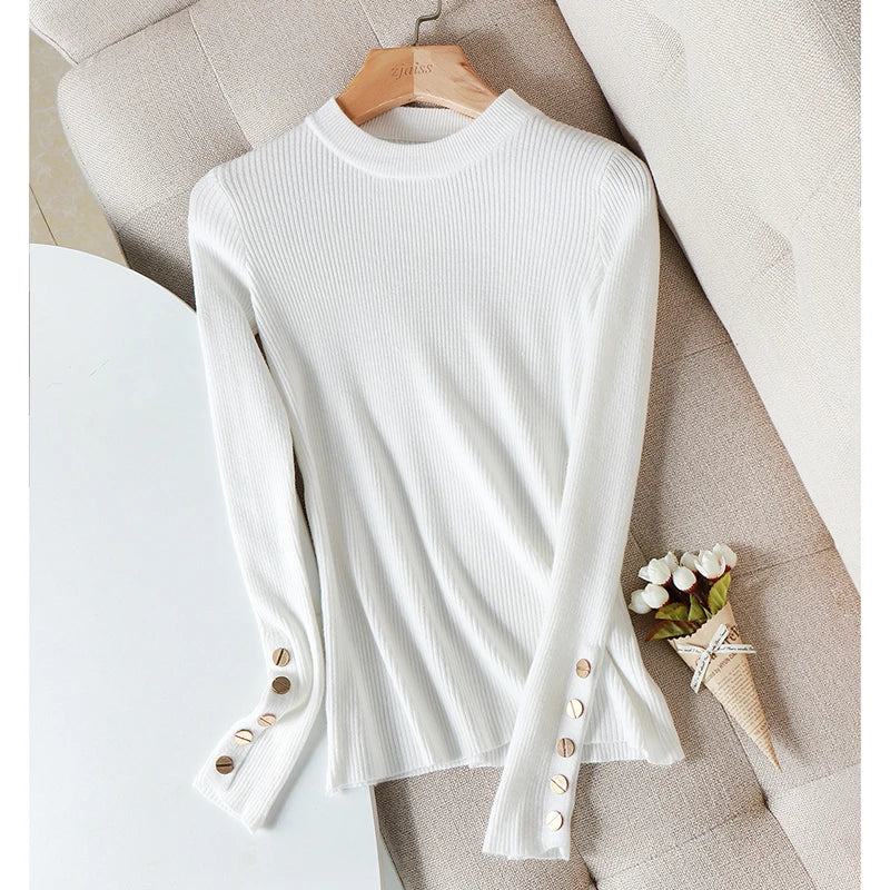 White ribbed sweater with button details on a hanger against a neutral background