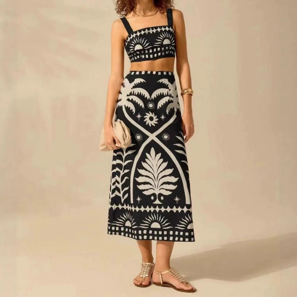 Woman wearing a black and white patterned dress against a beige background