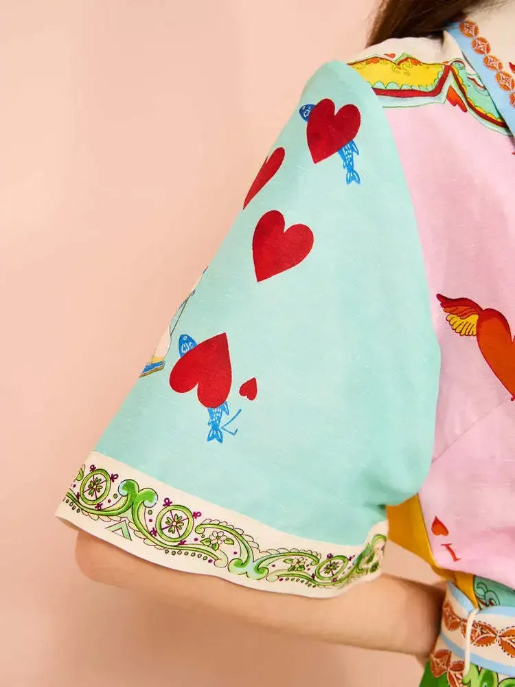 Colorful kimono with heart patterns on a light pink background