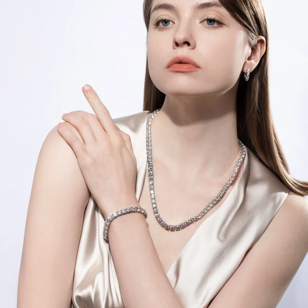 Woman wearing a diamond necklace and bracelet on a white background
