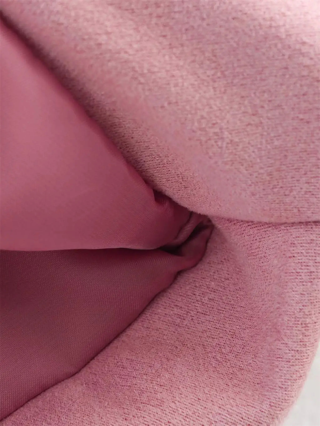 Close-up of pink fabric with a textured surface