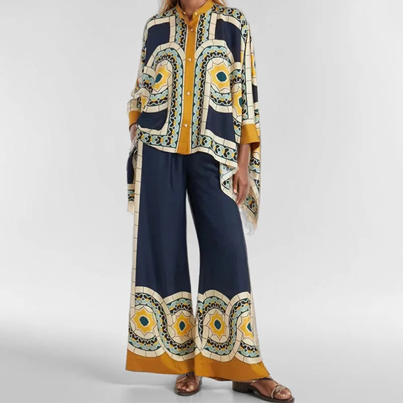Woman wearing a patterned outfit with a long coat and wide-leg pants on a white background
