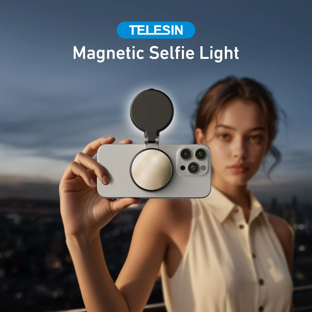 Person holding a phone with a magnetic selfie light attachment against a cityscape background
