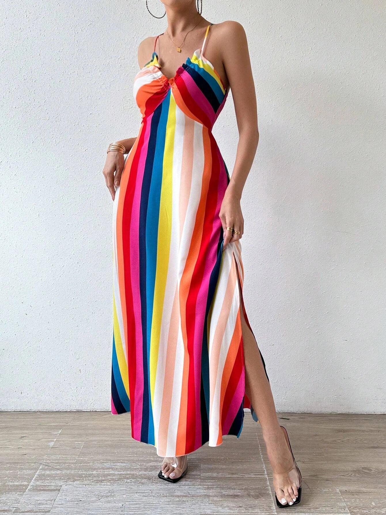 Woman wearing a colorful striped dress with a white background