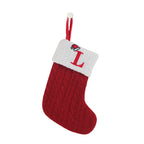 Red knitted Christmas stocking with white cuff featuring a letter 'L' on a white background