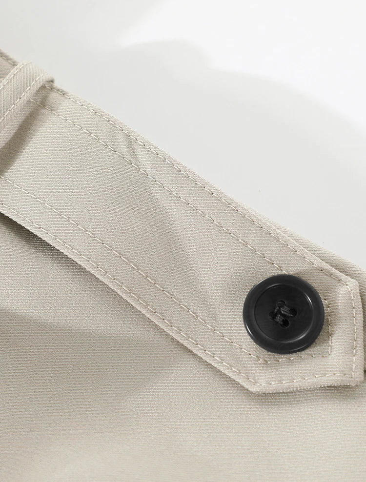 Close-up of a beige fabric with a button on a white background