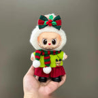 Toy figure with a festive outfit held in a hand against a plain background