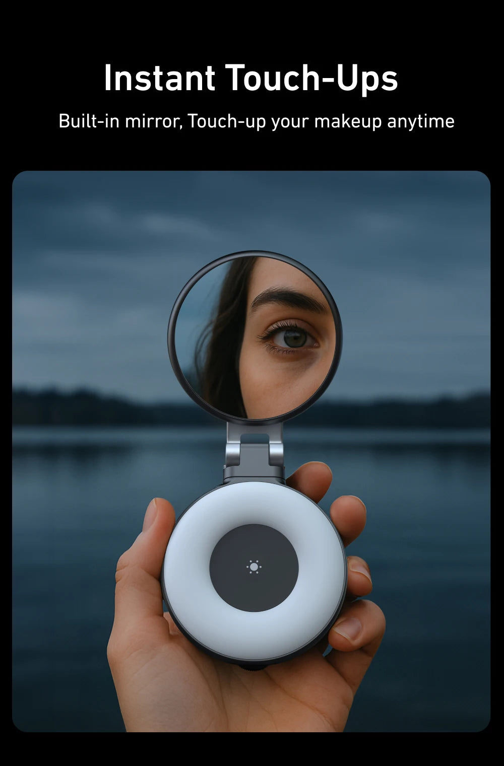 Hand holding a compact mirror with a built-in light, reflecting a person's eye against a dark background.