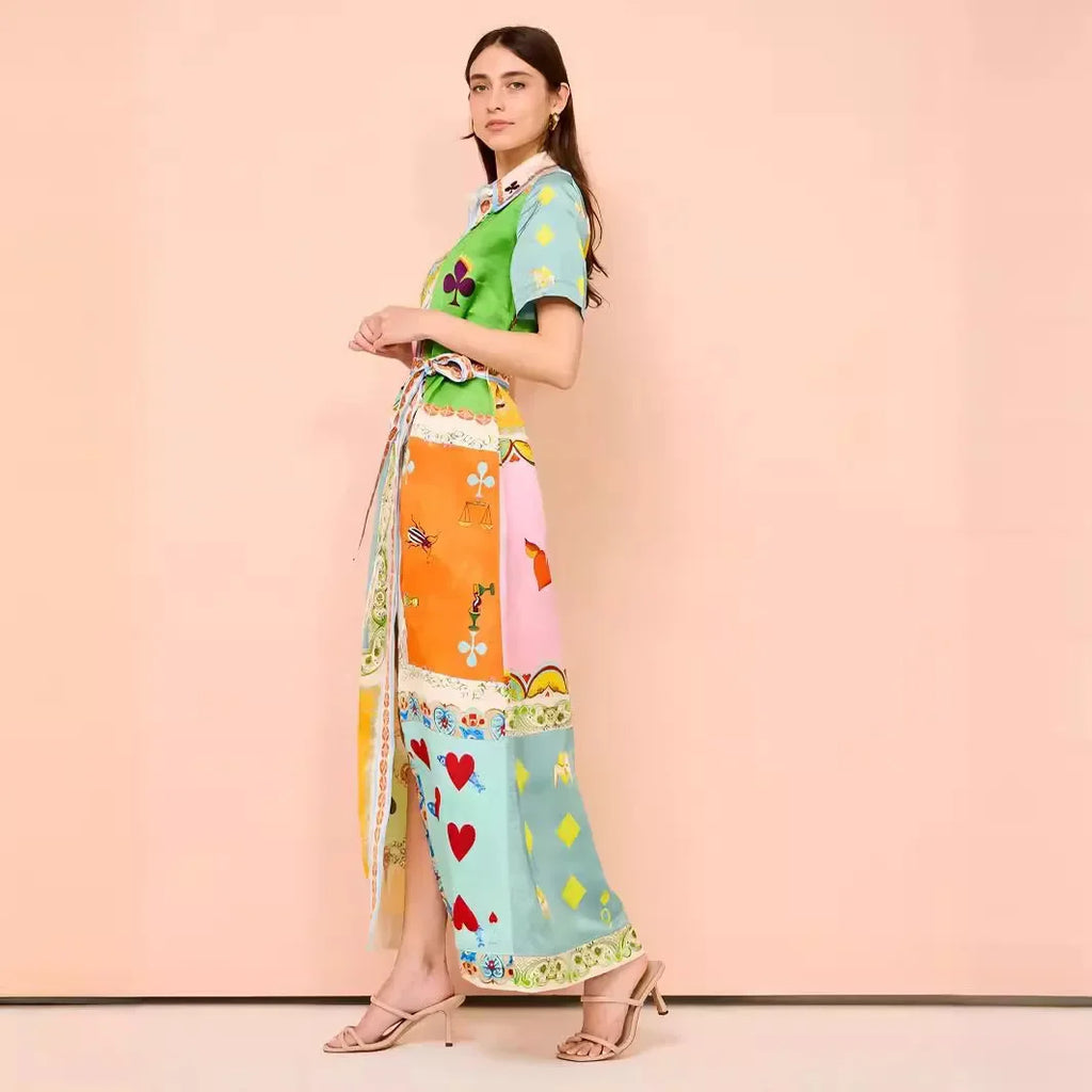 Woman wearing a colorful outfit with a patterned skirt on a pink background