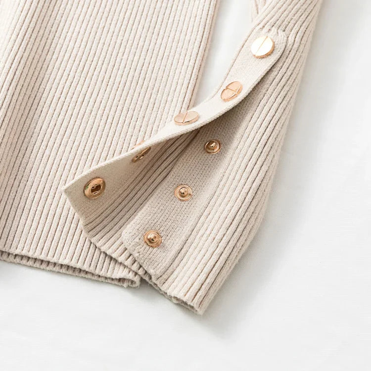 Beige ribbed sweater with button details on a white background