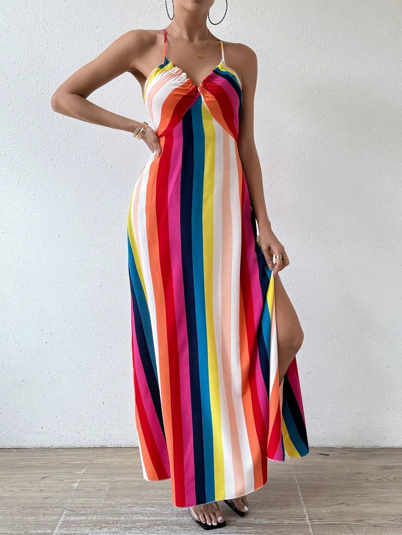 Woman wearing a colorful striped dress with a white background