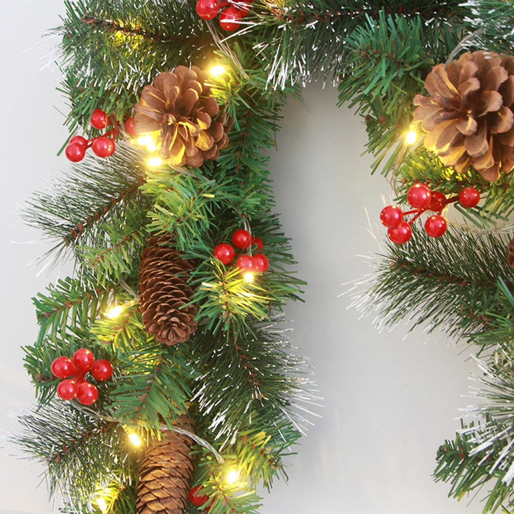 Christmas wreath with pine cones, red berries, and lights on a white background