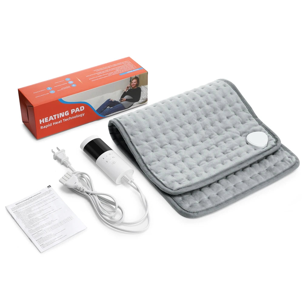 Gray heating pad with power cord, packaging, and user manual on a white background