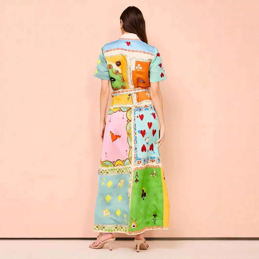 Woman wearing a colorful patchwork dress against a pink background