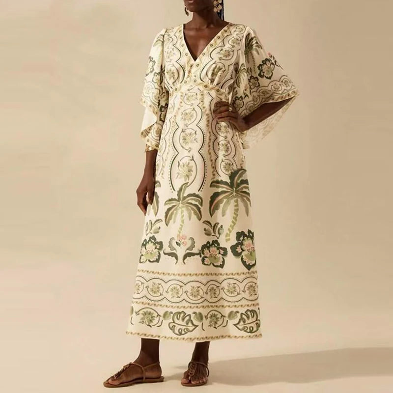 Woman wearing a long, floral-patterned dress against a beige background