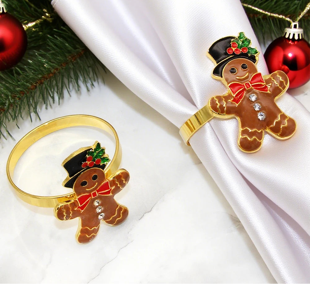 Gingerbread man napkin rings on a white napkin with Christmas decorations.