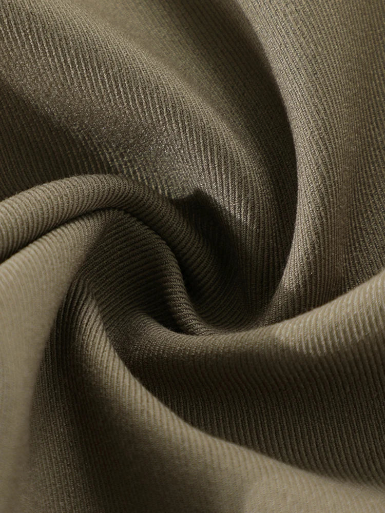 Close-up of olive green fabric with a textured pattern