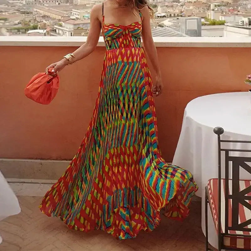 Woman in a colorful dress standing on a rooftop with a cityscape view.