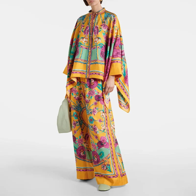 Person wearing a colorful floral outfit with a matching scarf on a white background