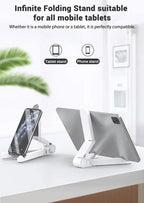Infinite folding stand for tablets and phones on a white surface with a blurred indoor background.
