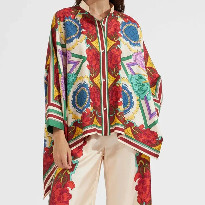 Colorful patterned shirt with geometric shapes and floral elements on a plain background