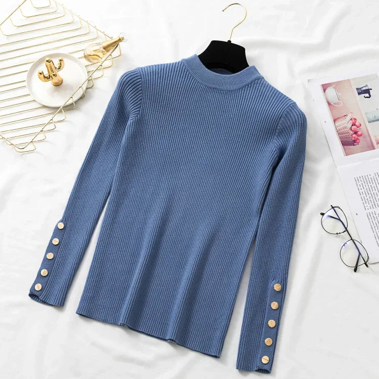 Blue sweater with button details on a white surface