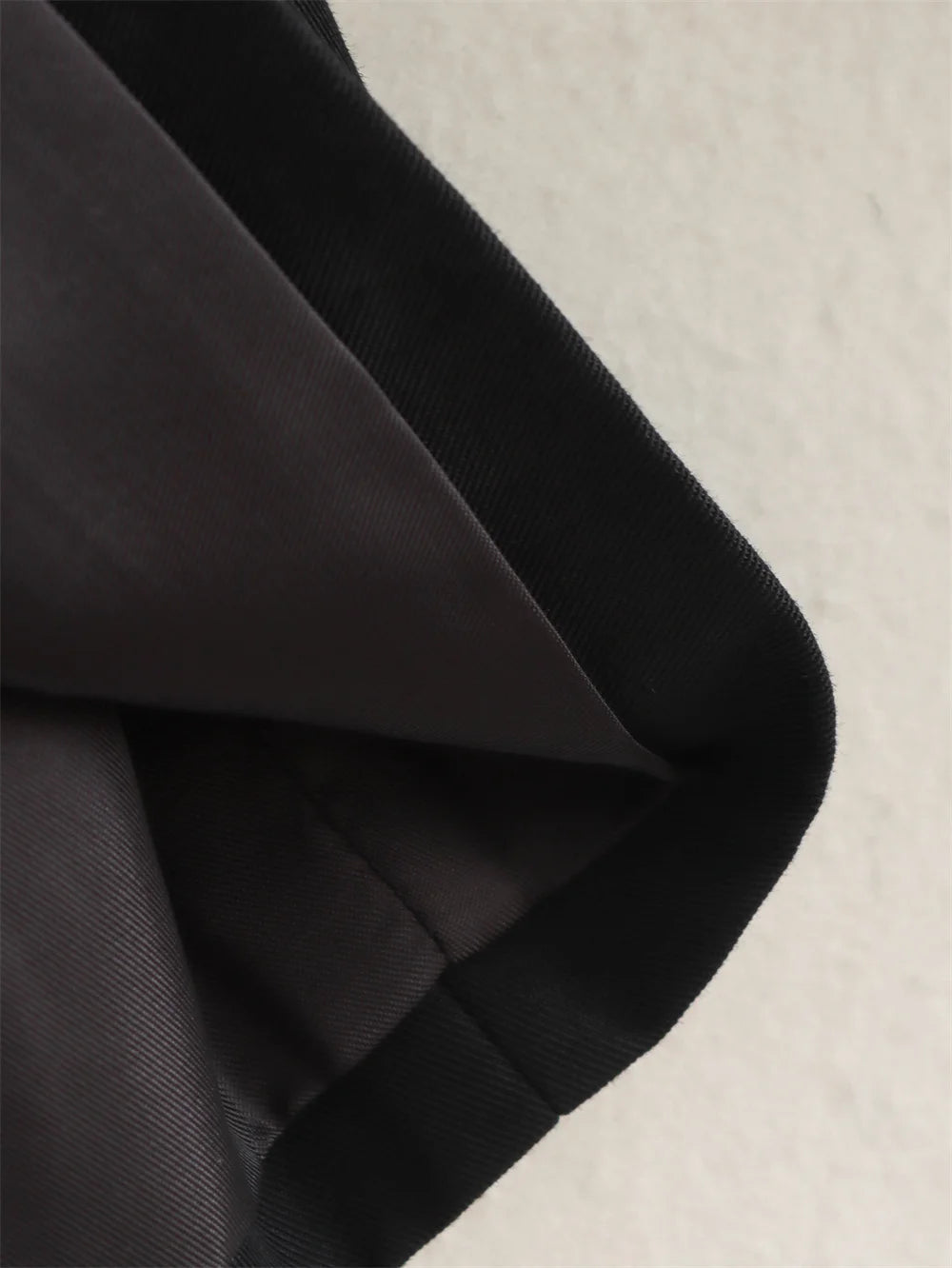 Close-up of black fabric on a beige background