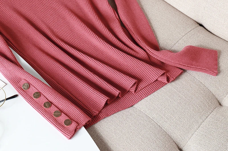 Pink jacket with buttons on a beige surface