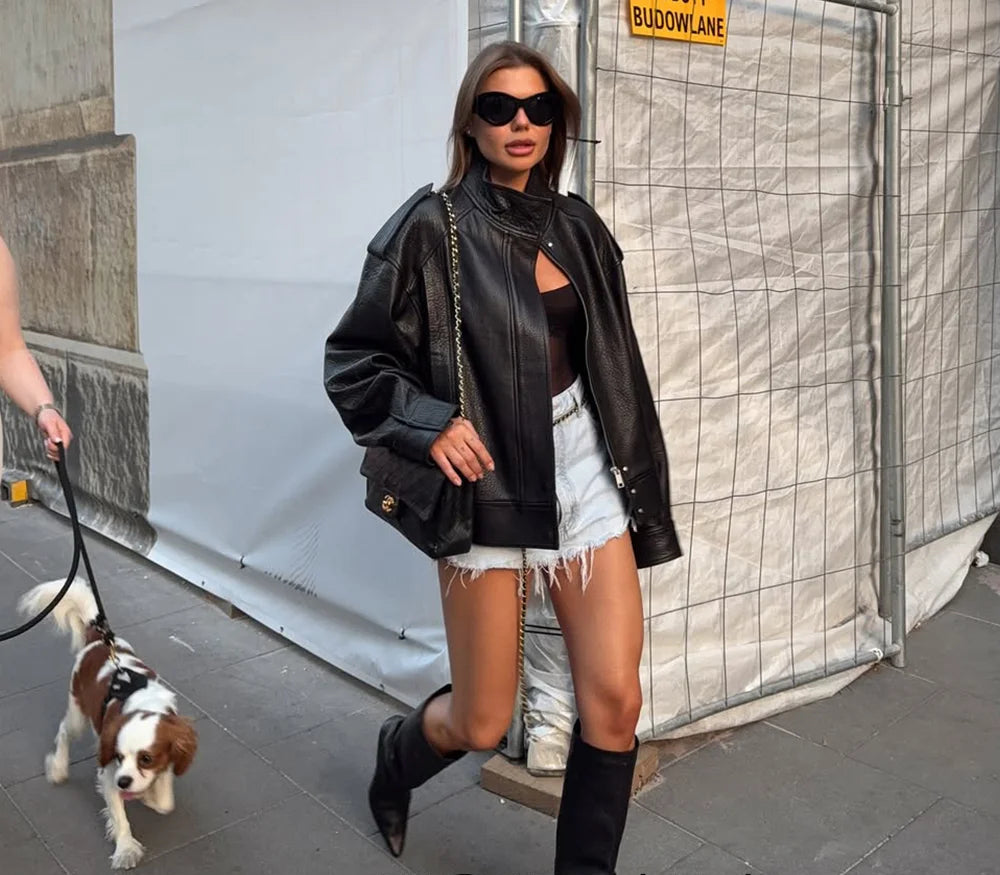 Woman walking a dog on a leash with a 'KONJALA' sign in the background