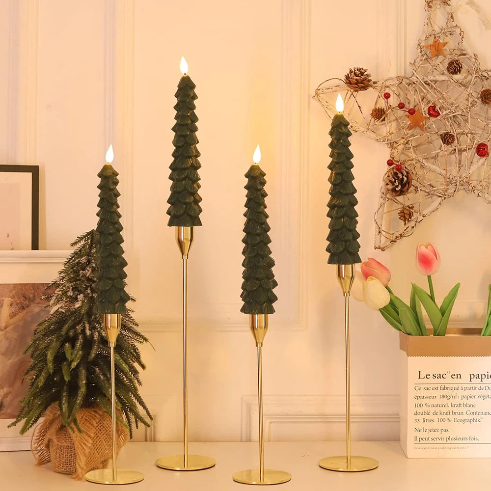 Decorative candlesticks shaped like Christmas trees on a table with a festive background.