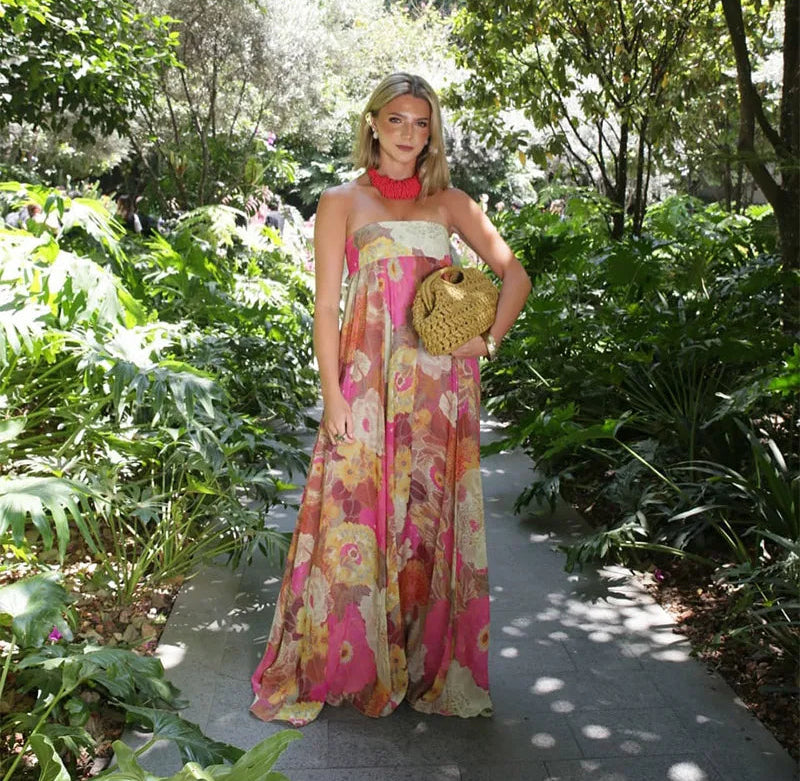 Woman in a floral dress standing in a garden