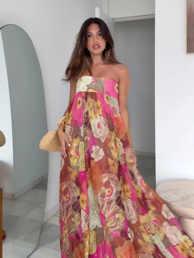 Woman wearing a colorful floral dress in an indoor setting