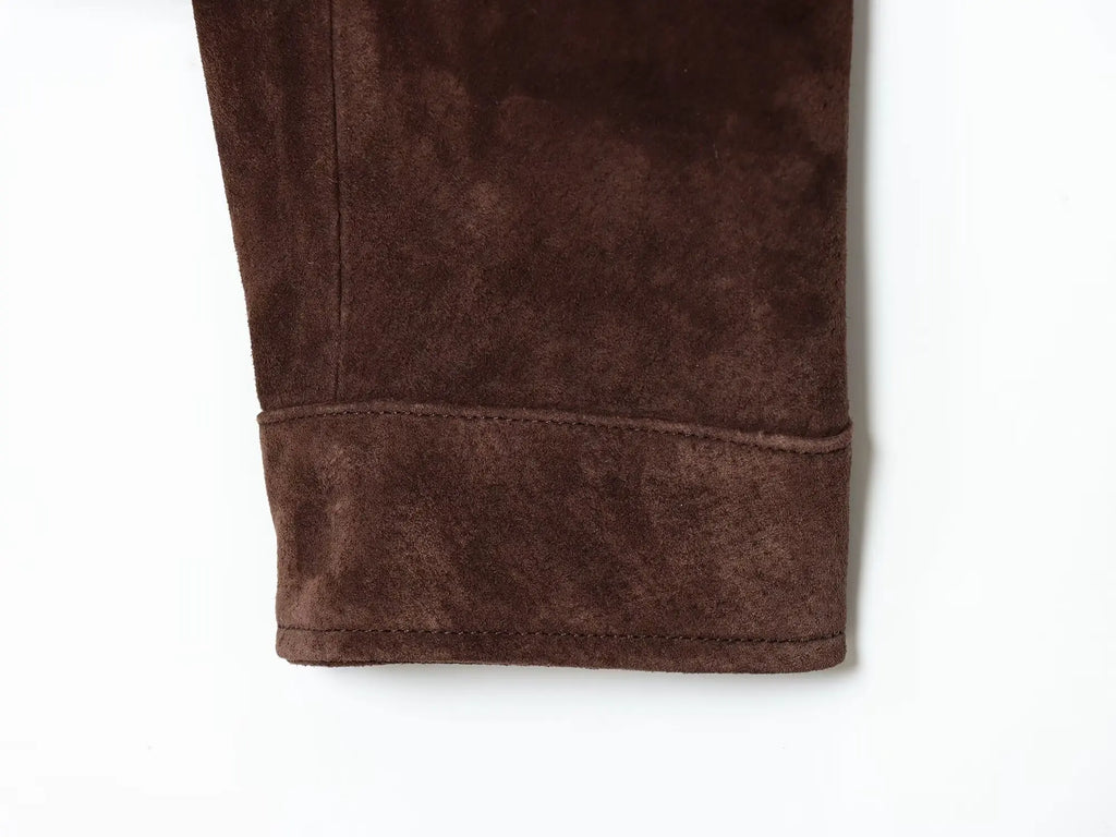 Close-up of brown fleece pants on a white background