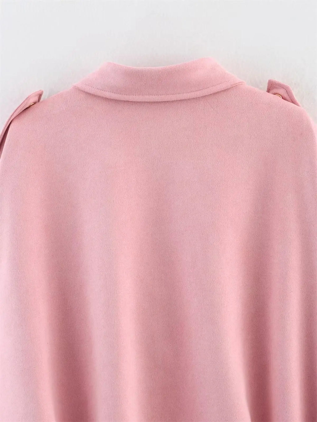 Close-up of a pink garment with a collar on a white background
