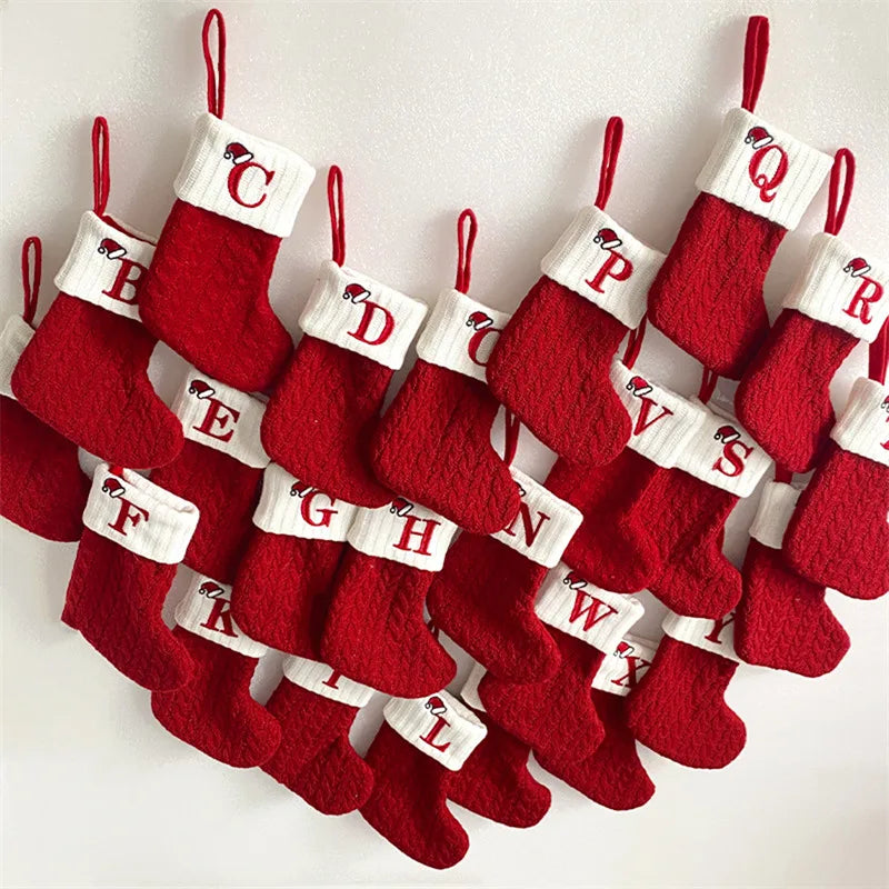 Set of red Christmas stockings with alphabet labels on a white background