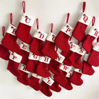 Set of red Christmas stockings with alphabet labels on a white background
