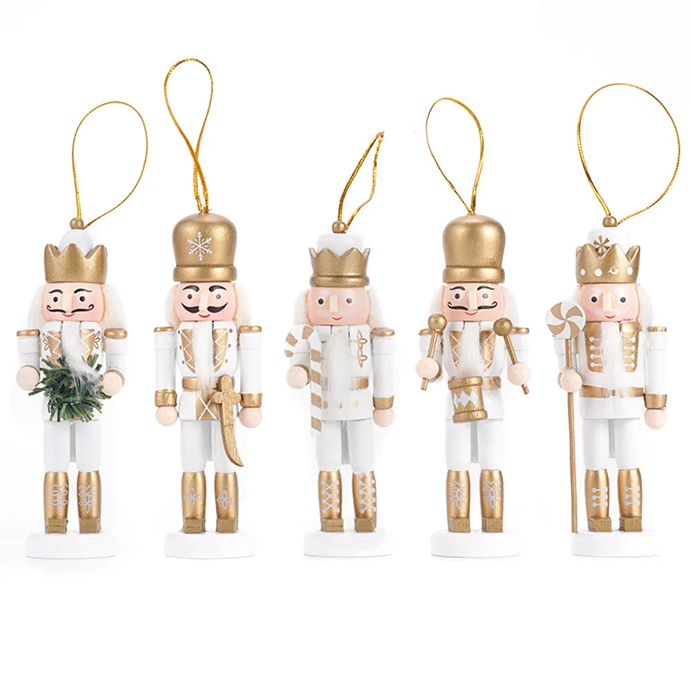 Set of five nutcracker ornaments with gold and white attire on a white background
