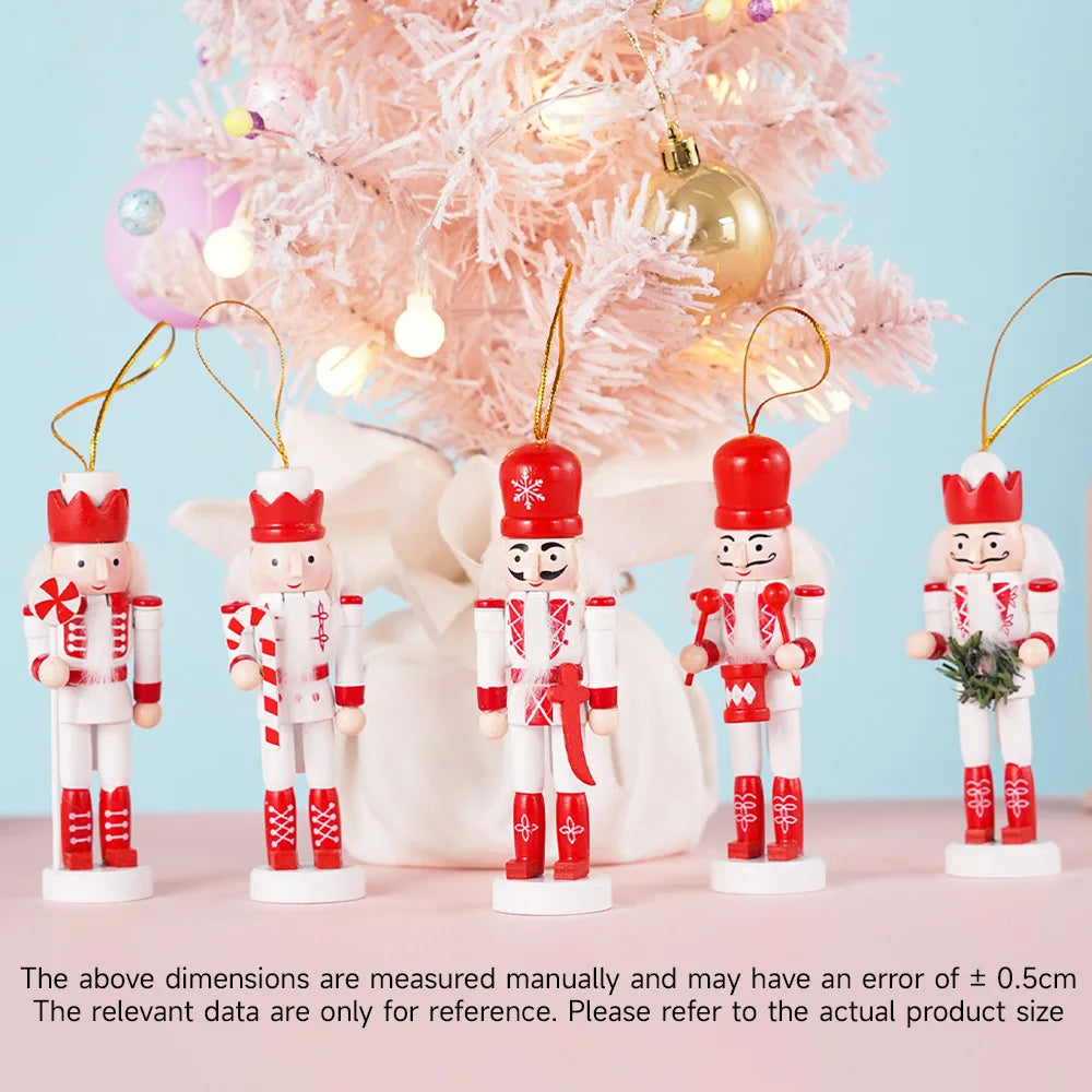 Set of nutcracker ornaments with red hats and white bodies in front of a decorated Christmas tree.
