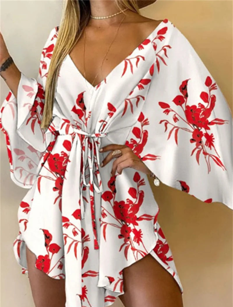White cover-up with red floral pattern worn by a person.