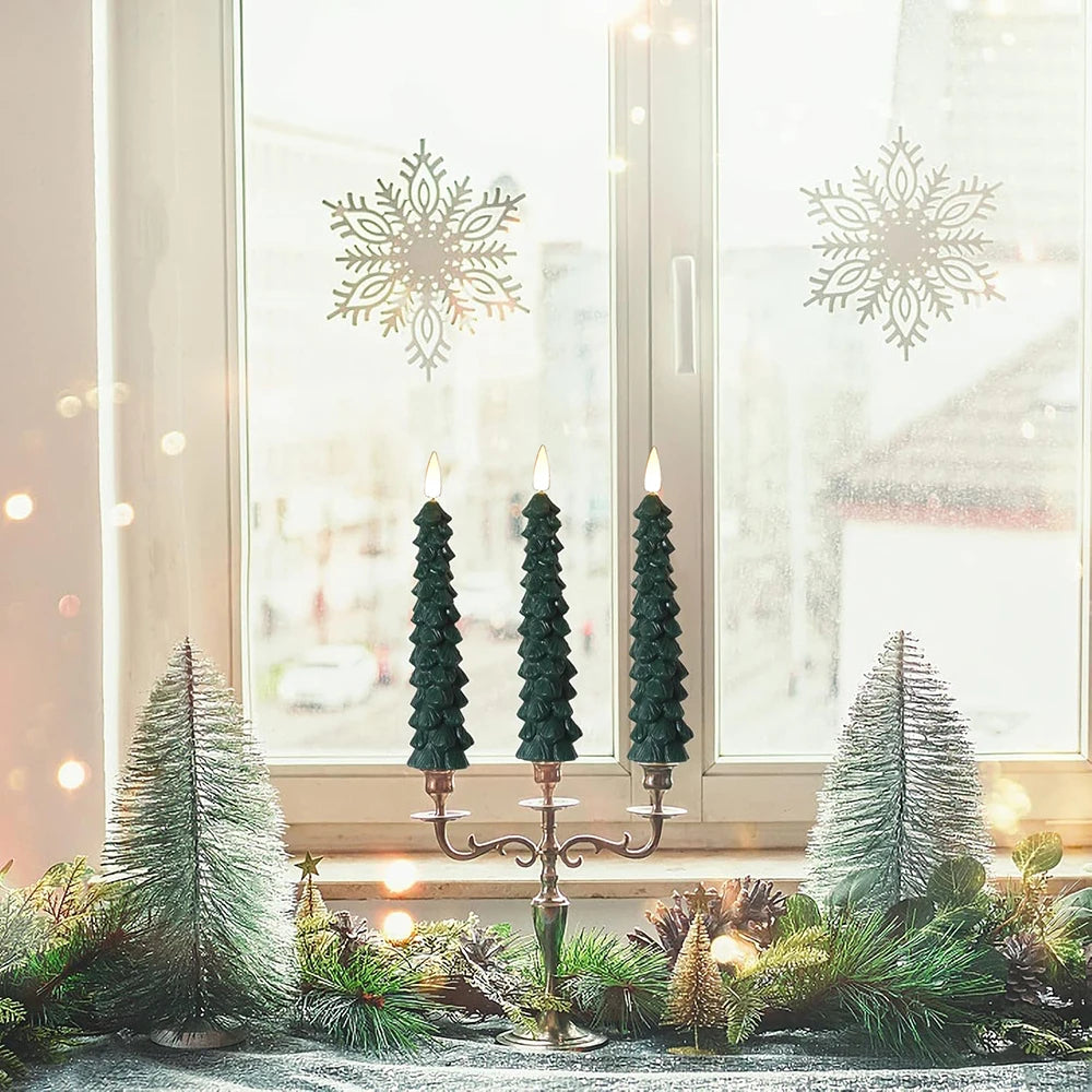 Decorative Christmas setup with trees and a candelabra in front of a window with snowflake decorations.