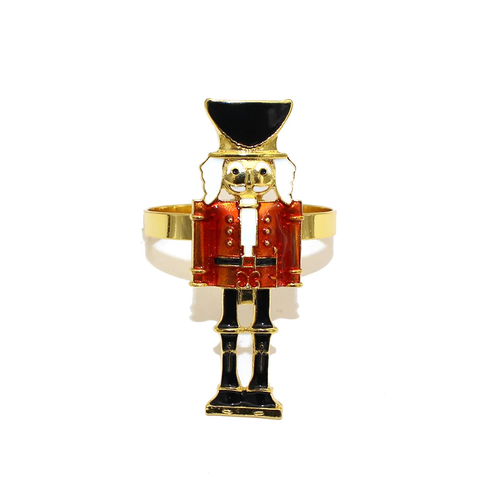 Nutcracker-shaped ring with gold, red, and black colors on a white background