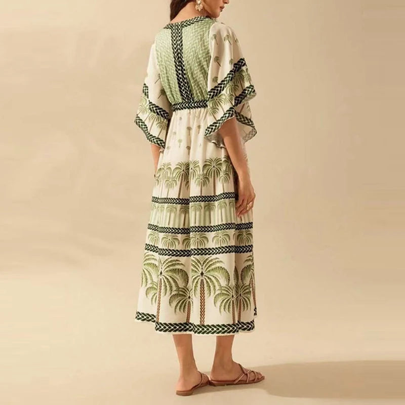 Woman wearing a green and white patterned dress on a beige background