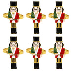 Set of six nutcracker-shaped napkin rings on a white background