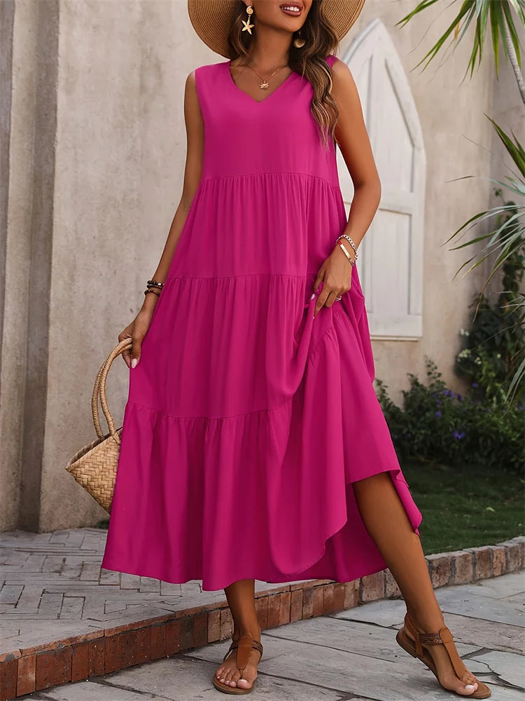 Woman wearing a pink dress standing outdoors with a neutral background