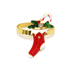 Decorative bracelet with red boot, holly, and candy cane design on a white background