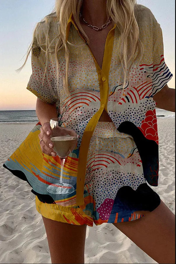 Person in a colorful outfit holding a drink on a beach